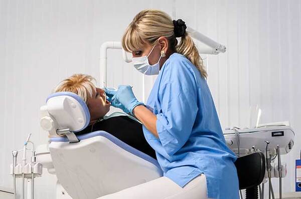 Woman at the dentist office with her female dentist.