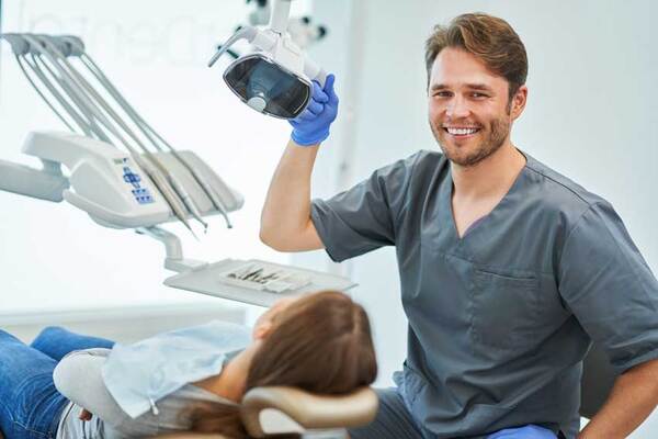 Dentist smiling with his patient.